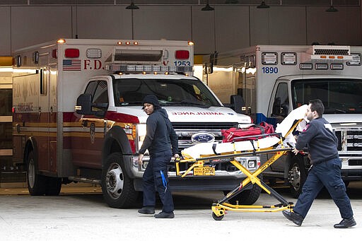 Emergency Medical Technicians wheel a collapsible wheeled stretcher into the emergency room at NewYork-Presbyterian Lower Manhattan Hospital, Wednesday, March 18, 2020, in New York. &quot;Do not go to the emergency room unless it is a true, immediate and urgent emergency,&quot; said Mayor Bill de Blasio, who pleaded Tuesday with people who suspect they have coronavirus symptoms to stay home and see if they improve in a few days before even calling a doctor. For most people, the new coronavirus causes only mild or moderate symptoms. For some it can cause more severe illness. (AP Photo/Mary Altaffer)