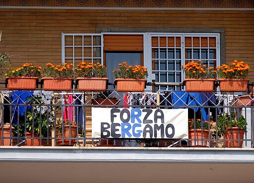 A banner reading &quot;Go Bergamo&quot;, with the colors of the soccer team of the Northern Italian city hardest hit by coronavirus, is seen, in spite of fierce rivalry between the two cities, in Rome, Sunday, March 22, 2020. For most people, the new coronavirus causes only mild or moderate symptoms. For some it can cause more severe illness, especially in older adults and people with existing health problems. (Mauro Scrobogna/LaPresse via AP)