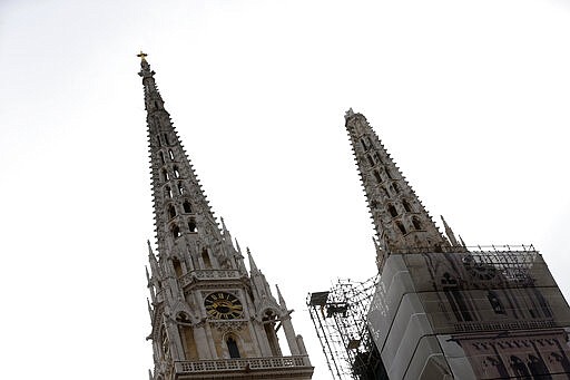 One of the damaged spires, right, of Zagreb's iconic cathedral is seen after an earthquake in Zagreb, Croatia, Sunday, March 22, 2020. The cathedral was rebuilt after it toppled in the 1880 earthquake. A strong earthquake shook Croatia and its capital on Sunday, causing widespread damage and panic. (AP Photo/Darko Bandic)