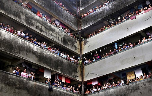 People clap from balconies in show of appreciation to health care workers at a Chawl in Mumbai, India, Sunday, March 22, 2020. India is Sunday observing a 14-hour &quot;people's curfew&quot; called by Prime Minister Narendra Modi in order to stem the rising coronavirus caseload in the country of 1.3 billion For most people, the new coronavirus causes only mild or moderate symptoms. For some it can cause more severe illness. (AP Photo/Rafiq Maqbool)