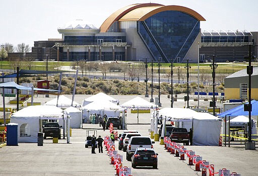 Motorists line up at Balloon Fiesta Park in Albuquerque, New Mexico at a new test site for the COVID-19 virus as it continues to spread among New Mexicans on Monday March 23, 2020. (Adolphe Pierre-Louis/The Albuquerque Journal via AP)