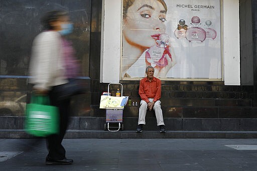 Tomas Gonzalez, 80, markets face masks and antibacterial gel to pedestrians in Mexico City, Monday, March 23, 2020. Gonzalez and his wife had been hawking sandwiches, but switched to selling coronavirus-related products last week. &quot;At 80-years-old, no one will give me work,&quot; said the former sales trainer.(AP Photo/Rebecca Blackwell)