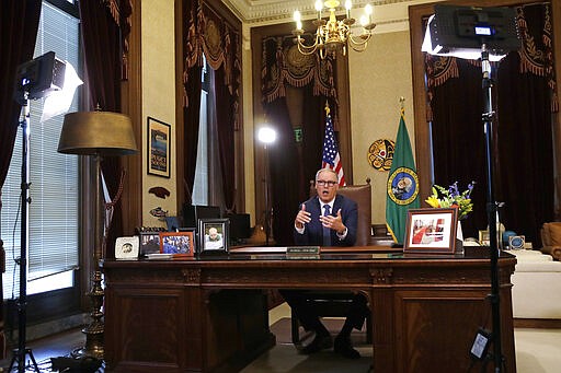 Washington Gov. Jay Inslee practices as he prepares to speak about additional plans to slow the spread of coronavirus before a televised address from his office Monday, March 23, 2020, in Olympia, Wash. The latest update from the Washington state Department of Health showed there have been at least 110 coronavirus deaths in the state and more than 2,200 confirmed cases. (AP Photo/Elaine Thompson)