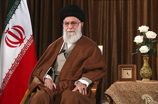 In this picture released by the official website of the office of the Iranian supreme leader, Supreme Leader Ayatollah Ali Khamenei sits prior to address nation on state television, in Tehran, Iran, Sunday, March 22, 2020. Iran's supreme leader Sunday refused U.S. assistance to fight the new coronavirus, citing an unfounded conspiracy theory that the virus could be man-made by America. (Office of the Iranian Supreme Leader via AP)