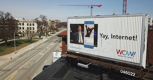 A WOW internet service billboard across from Ohio State University serves as a reminder of things to come as thousands of students will begin online classes on Monday in Columbus, Ohio, Sunday, March 22, 2020. Due to coronavirus, all in-person, face-to-face teaching has been suspended at the Ohio State University. Photographed March 22, 2020. (Doral Chenoweth/The Columbus Dispatch via AP)