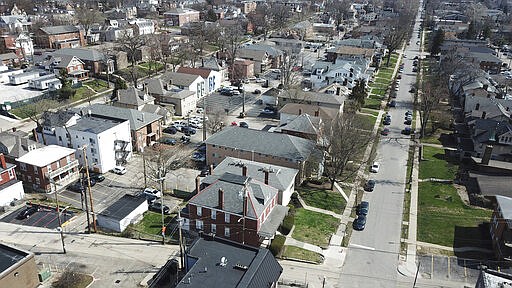 Off-campus apartments, such as those in this view looking east on E. 13th Ave., have had fewer social activities due to the coronavirus in Columbus, Ohio, Sunday, March 22, 2020. Due to coronavirus, all in-person, face-to-face teaching has been suspended at the Ohio State University. (Doral Chenoweth/The Columbus Dispatch via AP)