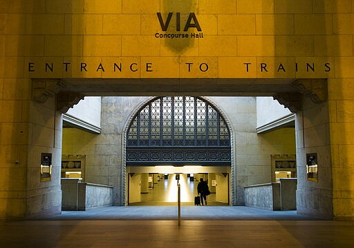 A lone person walks at Union Station in Toronto on Monday, March 23, 2020. Canadian Prime Minister Justin Trudeau says &quot;enough is enough. Go home and stay home.&quot;  Trudeau says staying at home is a duty and the government will enforce it if necessary. (Nathan Denette/The Canadian Press via AP)