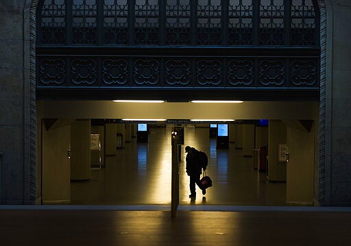 A lone person walks at Union Station in Toronto on Monday, March 23, 2020. Canadian Prime Minister Justin Trudeau says &quot;enough is enough. Go home and stay home.&quot;  Trudeau says staying at home is a duty and the government will enforce it if necessary.  (Nathan Denette/The Canadian Press via AP)