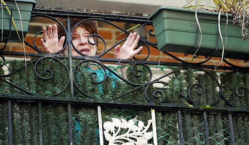 In this March 19, 2020 photo, Holocaust survivor Alice Rosenberg speaks to meal delivery volunteer Freida Rothman from her balcony in Brooklyn, New York. Many of the borough's Holocaust survivors, who are isolated in their homes because of coronavirus fears, are relying on meal deliveries from Jewish community organizations. (AP Photo/Jessie Wardarski)