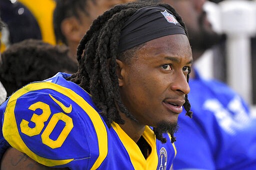 FILE - In this Dec. 29, 2019, file photo, Los Angeles Rams running back Todd Gurley sits on the bench during the second half of an NFL football game against the Arizona Cardinals in Los Angeles. The Atlanta Falcons have agreed to a one-year deal with three-time Pro Bowl running back Todd Gurley, one day after he was cut by the Los Angeles Rams. A person familiar with the deal told The Associated Press about the agreement on Friday, March 20, 2020, on condition of anonymity because the deal will not be official until Gurley passes a physical. (AP Photo/Mark J. Terrill, File)