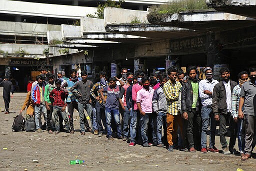 Indian passengers who got stranded at a bus terminal line up for free food being distributed by shop keepers during a day long lockdown amid growing concerns of coronavirus in Jammu, India, Sunday, March 22, 2020. India is observing a 14-hour &#147;people's curfew&#148; called by Prime Minister Narendra Modi in order to stem the rising coronavirus caseload in the country of 1.3 billion. India's government has made fervent appeals to the public to practice social distancing, but experts say, the same is nearly impossible in many Indian cities that are among the world's most densely populated areas. For most people, the new coronavirus causes only mild or moderate symptoms. For some it can cause more severe illness. (AP Photo/Channi Anand)