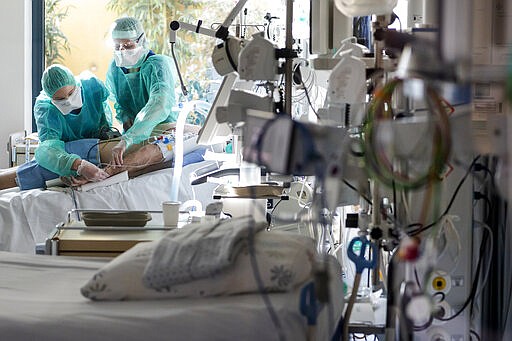 Medical personnel at work in the intensive care unit of the hospital Pourtales site &quot;Hospital Pourtales&quot; during the coronavirus disease (COVID-19) outbreak in Neuchatel, Switzerland, Monday, March 23, 2020. (Jean-Christophe Bott/Keystone via AP)