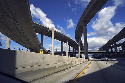 Extremely light traffic moves along the CA-110 highway towards downtown Los Angeles on Monday, March 23, 2020. Traffic is light as many people heeded warnings to stay home amid the coronavirus outbreak. California is one of the hardest-hit states, with more than 1,600 confirmed cases and 30 deaths. (AP Photo/Richard Vogel)