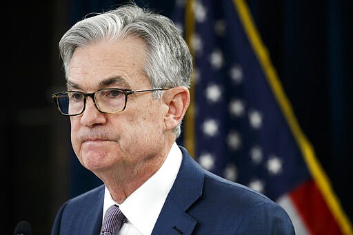 FILE - In this Tuesday, March 3, 2020 file photo, Federal Reserve Chair Jerome Powell pauses during a news conference to discuss an announcement from the Federal Open Market Committee, in Washington. In a series of sweeping steps, the U.S. Federal Reserve will lend to small and large businesses and local governments as well as extend its bond buying programs.  The announcement Monday, March 23 is part of the Fed's ongoing efforts to support the flow of credit through an economy ravaged by the viral outbreak.  (AP Photo/Jacquelyn Martin, File)