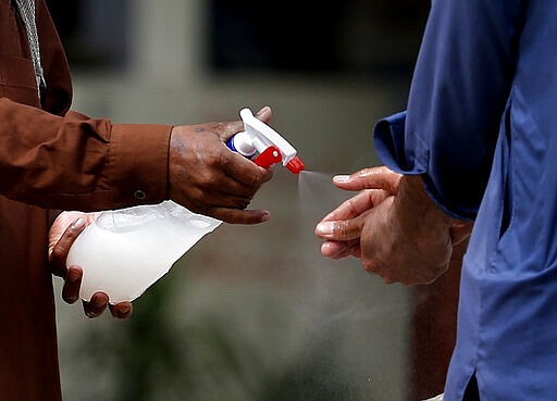 A volunteer washes hands with an antibacterial cleanser to help reduce the spread of the coronavirus outside a mosque in Rawalpindi, Pakistan, Monday, April 23, 2020. According to the World Health Organization, most people recover in about two to six weeks, depending on the severity of the illness. (AP Photo/Anjum Naveed)