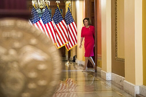 House Speaker Nancy Pelosi of Calif. arrives to read a statement outside her office on Capitol Hill, Monday, March 23, 2020, in Washington. (AP Photo/Andrew Harnik, Pool)