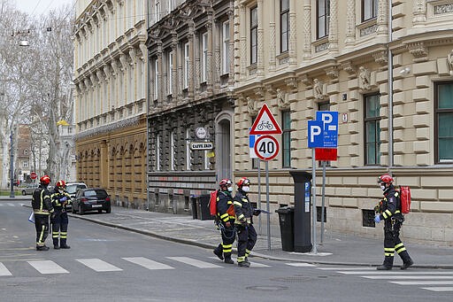 Firemen inspect damage in downtown Zagreb, Croatia after the earthquake, Monday, March 23, 2020. Croatia experienced a series of aftershocks a day after a strong earthquake triggered widespread damage and injured over 20 people in the capital. (AP Photo/Darko Bandic)