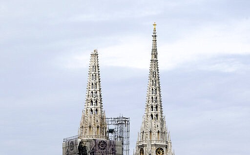 One of the damaged spires, left, of Zagreb's iconic cathedral is seen after an earthquake in Zagreb, Croatia, Sunday, March 22, 2020. The cathedral was rebuilt after it toppled in the 1880 earthquake. A strong earthquake shook Croatia and its capital on Sunday, causing widespread damage and panic. (AP Photo/Darko Bandic)