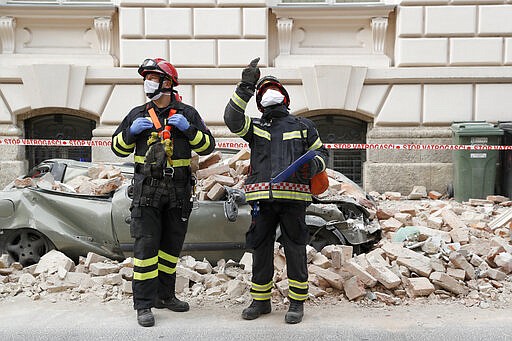 Firemen inspect damage after an earthquake in downtown Zagreb, Croatia, Monday, March 23, 2020. Croatia experienced a series of aftershocks a day after a strong earthquake triggered widespread damage and injured over 20 people in the capital. (AP Photo/Darko Bandic)