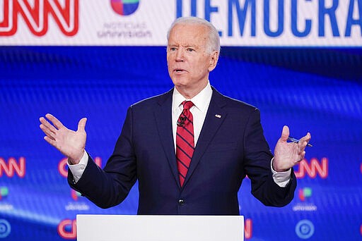 FILE- In this Sunday, March 15, 2020 file photo, former Vice President Joe Biden, participates in a Democratic presidential primary debate at CNN Studios in Washington. Joe Biden swept to victory in Florida, Illinois and Arizona on Tuesday, increasingly pulling away with a Democratic presidential primary upended by the coronavirus and building pressure on Bernie Sanders to abandon his campaign. (AP Photo/Evan Vucci, File)