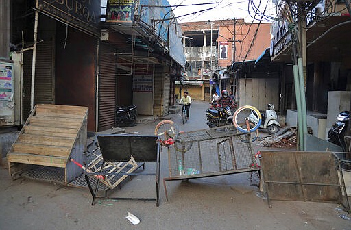 A street is locked down as a precautionary measure against COVID-19 in Hyderabad, India, Monday, March 23, 2020. Authorities have gradually started to shutdown much of the country of 1.3 billion people to contain the outbreak. For most people, the new coronavirus causes only mild or moderate symptoms. For some it can cause more severe illness. (AP Photo/Mahesh Kumar A.)