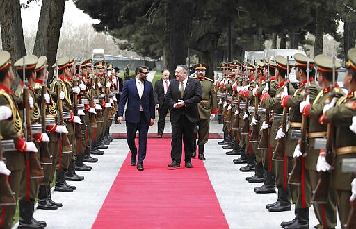 U.S. Secretary of State Mike Pompeo, center right, and Afghan National Security Adviser Hamdullah Mohib, center left, review an honor guard, during an arrival ceremony at the Presidential Palace in Kabul, Afghanistan, Monday, March 23, 2020. Pompeo was in Kabul on an urgent visit Monday to try to move forward a U.S. peace deal signed last month with the Taliban, a trip that comes despite the coronavirus pandemic, at a time when world leaders and statesmen are curtailing official travel. (Afghan Presidential Palace via AP)