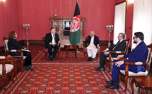 U.S. Secretary of State Mike Pompeo, center left, meets with Afghan President Ashraf Ghani, center right, at the Presidential Palace in Kabul, Afghanistan, Monday, March 23, 2020. Pompeo was in Kabul on an urgent visit Monday to try to move forward a U.S. peace deal signed last month with the Taliban, a trip that comes despite the coronavirus pandemic, at a time when world leaders and statesmen are curtailing official travel. (Afghan Presidential Palace via AP)