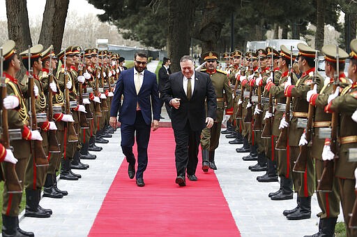 U.S. Secretary of State Mike Pompeo, right, and Afghanistan's National Security Adviser Hamdullah Mohib, arrives at the Presidential Palace in Kabul, Afghanistan, Monday, March 23, 2020. Pompeo was in Kabul on an urgent visit Monday to try to move forward a U.S. peace deal signed last month with the Taliban, a trip that comes despite the coronavirus pandemic, at a time when world leaders and statesmen are curtailing official travel. (Afghan Presidential Palace via AP)