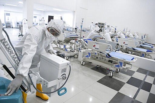 Staff inspect medical equipments at an emergency hospital set up amid the new coronavirus outbreak in Jakarta, Indonesia, Monday, March 23, 2020. Indonesia has changed towers built to house athletes in the 2018 Asian Games to emergency hospitals with a 3,000-bed capacity in the country's hard-hit capital, where new patients have surged in the past week. (Hafidz Mubarak A/Pool Photo via AP)