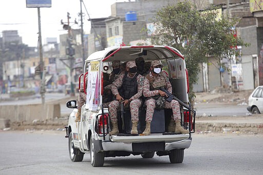 Security personnel patrol after a government announced to lockdown the city for concerns over the spread of the coronavirus in Karachi, Pakistan, Monday, March 23, 2020. The vast majority of people recover from the virus. According to the World Health Organization, most people recover in about two to six weeks, depending on the severity of the illness. (AP Photo/Fareed Khan)