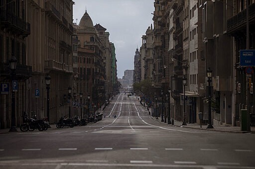 A view of Via Laietana street as authorities control public movements in Barcelona, Spain, Sunday, March 22, 2020. Spanish health authorities say intensive care units in the hardest-hit areas of Spain are close to their limit. The army was building a field hospital with 5,500 beds in a convention center in Madrid, where hotels are also being turned into wards for virus patients without serious breathing problems. For some people the COVID-19 coronavirus causes mild or moderate symptoms, but for some it causes severe illness. (AP Photo/Emilio Morenatti)