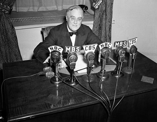 FILE - In this Feb. 27, 1941 file photo President Franklin D. Roosevelt speaks on the radio from the Oval Room of the White House. During an extraordinary 12 years in office, Roosevelt guided the nation through a bleak period of Depression-era unemployment, a severe Midwest drought known as the Dust Bowl and battle against the Nazis and Japanese in World War II. (AP Photo/Henry Griffin, File)