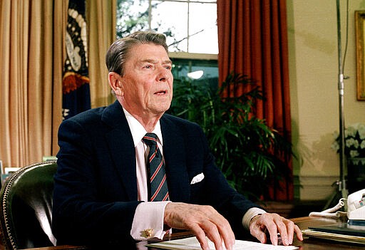 FILE - This Jan. 28, 1986 file picture shows U.S. President Ronald Reagan in the Oval Office of the White House after a televised address to the nation about the space shuttle Challenger explosion. Reagan comforted a shocked nation after it watched in January 1986 as the first American astronauts were killed when the Challenger space shuttle exploded in midair over Florida. (AP Photo/Dennis Cook, File)