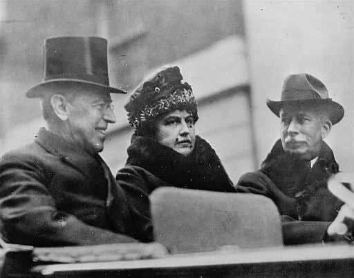 FILE - In this Oct. 11, 1918, file photo first lady Edith Wilson, center, and President Woodrow Wilson, left, arrive in New York to take part in the Liberty Day Parade. Woodrow Wilson was more focused on the end of World War I than a flu virus that was making its way around the globe, ultimately sickening hundreds of thousands of Americans, including him. (AP Photo, File)