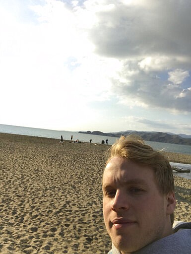 In this photo provided by Lance Sell, Sell takes a selfie on a San Francisco beach while walking, Friday, March 20, 2020. Sell, 19, is a freshman at Lehigh University. His parents are in Spain so he is staying with friends and sheltering in place. He says a lot of people his age are &quot;spooked.&quot; (Lance Sell via AP)