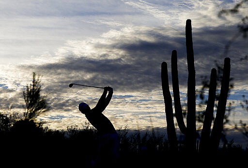 FILE - In this Feb. 23, 2014 file photo, Jason Day watches his tee shot on the second hole in his match against Rickie Fowler during the fifth round of the Match Play Championship golf tournament in Marana, Ariz. Municipal leaders criticized Arizona Gov. Doug Ducey Tuesday, March 24, 2020 over his decision to classify some businesses like golf courses as &quot;essential&quot; during the coronavirus pandemic. Mayors of five different cities, including Tucson and Flagstaff, sent the Republican governor a letter Tuesday saying his executive order should not have included golf courses and payday lenders in the definition of &quot;essential services&quot; that cannot be shut down. (AP Photo/Chris Carlson, File)