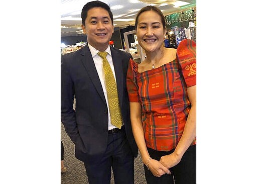 In this late February 2020, photo, Carlo Navarro poses with his wife Evie Navarro for a family photo during a trip to Tokyo. Days after he was cleared and discharged from hospital, Carlo Navarro shared his COVID-19 experience on a Facebook public post. (Carlo Navarro via AP)