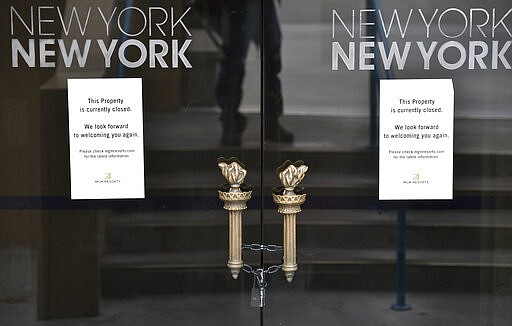 FILE - In this March 18, 2020 file photo, a padlock secures a set of doors at the New York-New York hotel-casino after all the casinos and non-essential businesses in the state were ordered to shut down due to the coronavirus in Las Vegas. The emerging coronavirus pandemic has spurred a lawsuit by a Las Vegas attorney with a background in big cases, who is seeking compensation from the Chinese government for more than 32 million small U.S. businesses that have lost income and profits as a result of the outbreak. Eglet seeks class-action status and said Tuesday, March 24, 2020 he believes damages for Chinese &quot;reckless&quot; and &quot;negligent&quot; conduct could be in the trillions of dollars. They seek compensation from the government of China. . (AP Photo/David Becker, File)