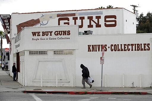 CORRECTS TO CULVER CITY, INSTEAD OF LOS ANGELES  Guns are advertised for sale at a gun shop Tuesday, March 24, 2020, in Culver City, Calif. Los Angeles County Sheriff Alex Villanueva said he would like to see gun shops shut down. &quot;We will be closing them, they are not an essential function,&quot; Villanueva said. Adding guns to households where more people are at home during a crisis increases the risk that someone will be shot, he said. (AP Photo/Marcio Jose Sanchez)