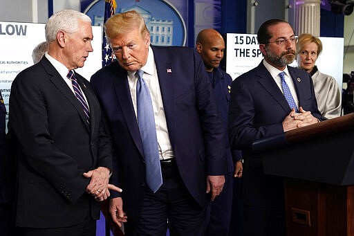 President Donald Trump listens to Vice President Mike Pence, left, as Health and Human Services Secretary Alex Azar speaks during a press briefing with the coronavirus task force, in the Brady press briefing room at the White House, Monday, March 16, 2020, in Washington. (AP Photo/Evan Vucci)