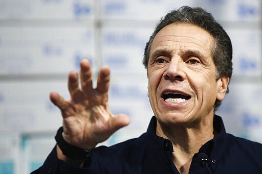 New York Gov. Andrew Cuomo speaks during a news conference against a backdrop of medical supplies at the Jacob Javits Center that will house a temporary hospital in response to the COVID-19 outbreak, Tuesday, March 24, 2020, in New York. Cuomo sounded his most dire warning yet about the coronavirus pandemic, saying the infection rate in New York is accelerating and the state could be as close as two weeks away from a crisis that projects 40,000 people in intensive care. (AP Photo/John Minchillo)