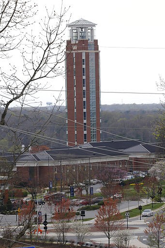 Liberty University's Freedom Tower looms over campus as students were welcomed back to the university's campus, Tuesday March 24 , 2020, in Lynchburg, Va. Officials in Lynchburg, said Tuesday they were fielding complaints and concerns about the hundreds of students that have returned from their spring break to Liberty University, where President Jerry Falwell Jr. has welcomed them back amid the coronavirus pandemic. (AP Photo/Steve Helber)