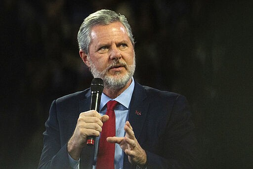 FILE - In this, Nov. 13 2019, file photo, Liberty University President Jerry Falwell Jr. talks to Donald Trump Jr. about his new book &quot;Triggered&quot; during convocation at Liberty University in Lynchburg, Va. Officials in Lynchburg said Tuesday they were fielding complaints and concerns about the hundreds of students that have returned from their spring break to Liberty University, where President Jerry Falwell Jr. has welcomed them back amid the coronavirus pandemic. (Emily Elconin/The News &amp; Advance via AP)