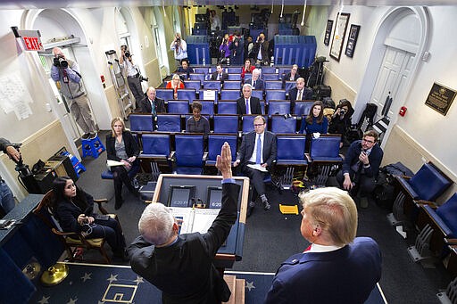 Dr. Anthony Fauci, left, director of the National Institute of Allergy and Infectious Diseases, speaks as President Donald Trump listens, about the coronavirus in the James Brady Briefing Room, Tuesday, March 24, 2020, in Washington. (AP Photo/Alex Brandon)