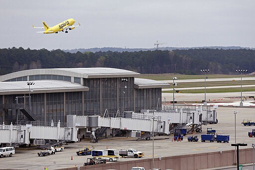 A passenger jet takes off at Raleigh Durham International Airport in Raleigh, N.C., Tuesday, March 24, 2020. The coronavirus has had a negative impact on the travel industry as many flights are canceled or delayed. (AP Photo/Gerry Broome)