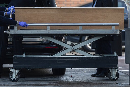 Undertakers carry a coffin of a person who died of COVID-19 at the La Almudena cemetery in Madrid, Spain, Monday, March 23, 2020. As cases in China ebbed, the dangers to Europe and the U.S. have grown exponentially, although Germany on Monday cautiously reported some flattening of its infection curve. More than 1.5 billion around the world have been told to stay in their homes. For most people, the new coronavirus causes only mild or moderate symptoms. For some it can cause a more serious illness. (AP Photo/Bernat Armangue)