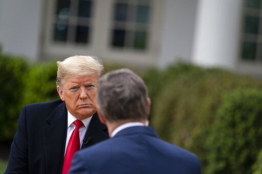 President Donald Trump listens to a question from host Bill Hemmer during a FOX News Chennel virtual town hall with members of the coronavirus task force, in the Rose Garden at the White House, Tuesday, March 24, 2020, in Washington. (AP Photo/Evan Vucci)