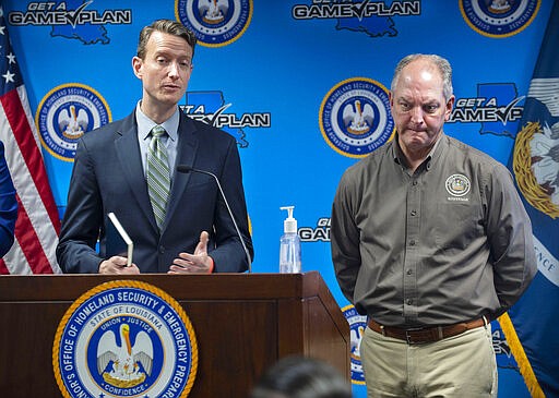 The seriousness of the situation weighs on the face of Louisiana Gov. John Bel Edwards, right, as Alex Billioux, M.D., left, Assistant Secretary of Health for the Louisiana Dept. of Health's Office of Public Health, answers a question at a briefing of media members on the state's coronavirus response at the Governor's Office of Homeland Security &amp; Emergency Management Tuesday, March 24, 2020, in Baton Rouge, La. (Travis Spradling/The Advocate via AP, Pool)