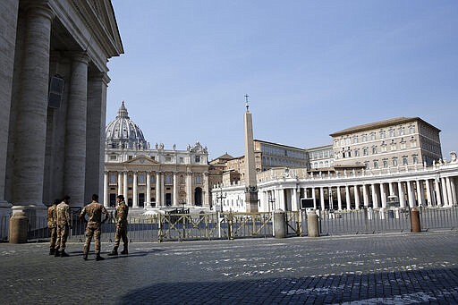 Italian soldiers patrol the area in front of an empty St. Peter's Square, at the Vatican, Sunday, March 22, 2020. During his weekly Sunday blessing, held due to virus concerns in his private library in the Apostolic Palace, Pope Francis urged all Christians to join in reciting the ''Our Father'' prayer next Wednesday at noon. For most people, the new coronavirus causes only mild or moderate symptoms. For some it can cause more severe illness, especially in older adults and people with existing health problems. (AP Photo/Alessandra Tarantino)