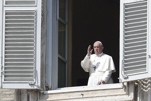 Pope Francis delivers his blessing from the window of his private library overlooking St. Peter's Square, at the Vatican, Sunday, March 22, 2020. During his weekly Sunday blessing, held due to virus concerns in his private library in the Apostolic Palace, he urged all Christians to join in reciting the &#145;&#146;Our Father&#146;&#146; prayer next Wednesday at noon. And he said that he would lead a global blessing to an empty St. Peter&#146;s Square on Friday. For most people, the new coronavirus causes only mild or moderate symptoms. For some it can cause more severe illness, especially in older adults and people with existing health problems. (AP Photo/Andrew Medichini)